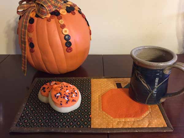 "Pumpkin” is a Free Halloween Quilted Mug Rug Pattern designed by Chris and Annette from Needlepointers!